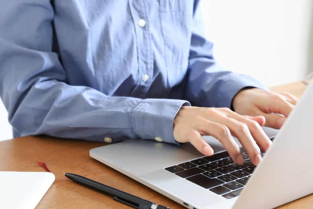 タイピングする青スーツの男性