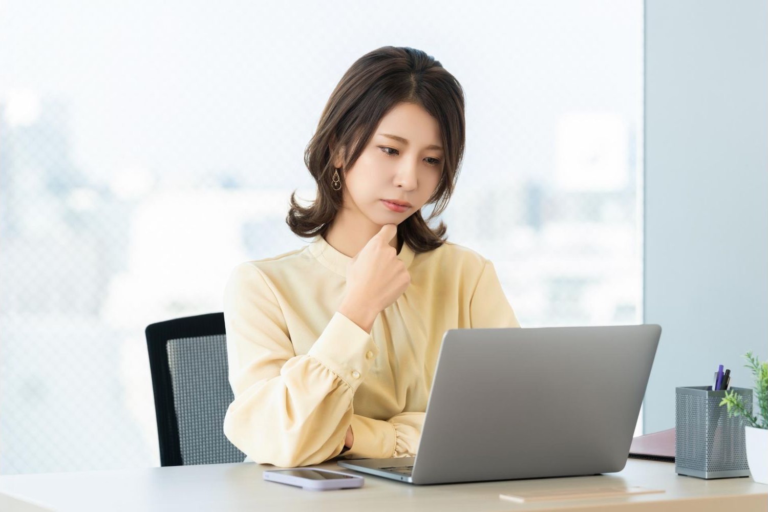 オフィスでノートパソコンを操作する女性