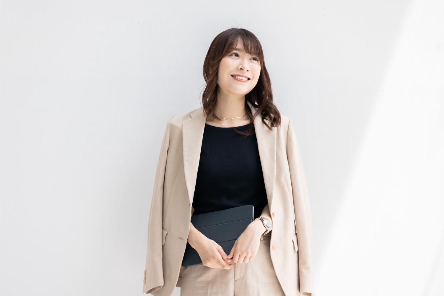 ベージュのジャケットを着て立つ女性