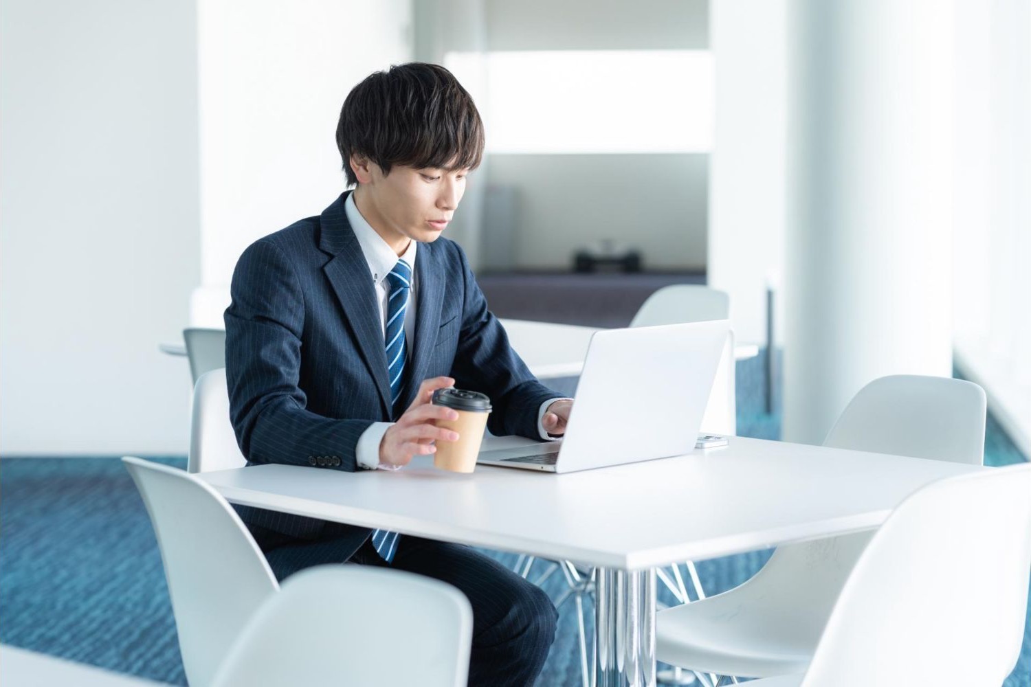 会議室でノートパソコンを操作する男性会社員